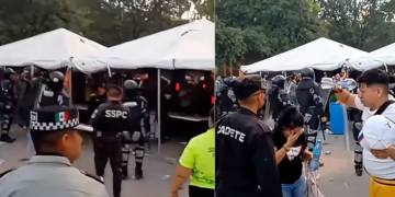 Crowd Under White Tents with Uniformed Security Personnel Monitoring an Outdoor Event Area. - Vecinos Unidos